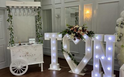 Prosecco cart, light up letters and floral arrangements