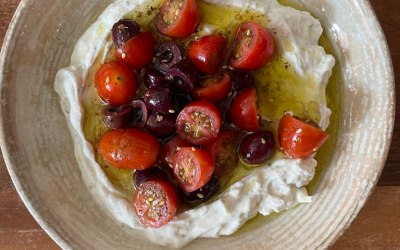 Confit garlic labneh with tomato and olive salad