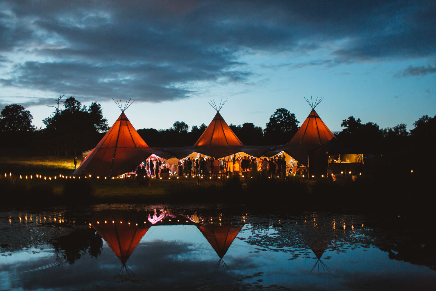 Image of marquee tents in a field at night