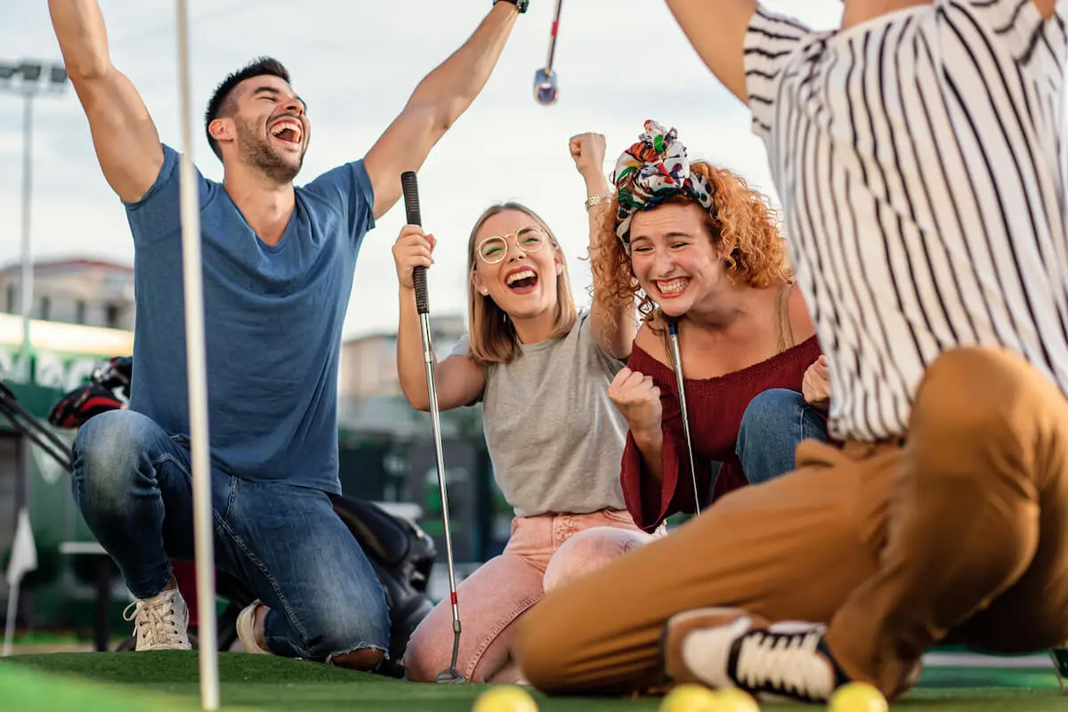 Group of team members celebrating whilst playing crazy golf