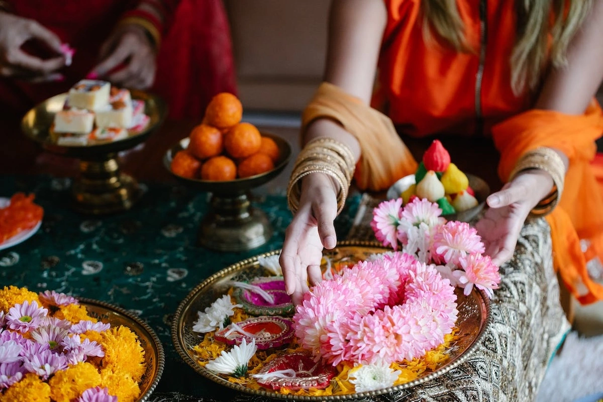 Image of a table of vibrant indian decorations and flower petals