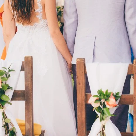 Image of the back of a bride and groom at a wedding reception