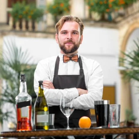 Image of a mobile bartender with his arms folded with cocktail making equipment in front of him
