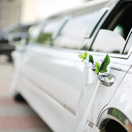 Up close image of a white limousine decorated ready for a wedding