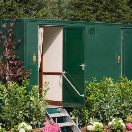 Image of a luxury range of green portable toilets at an outdoor wedding