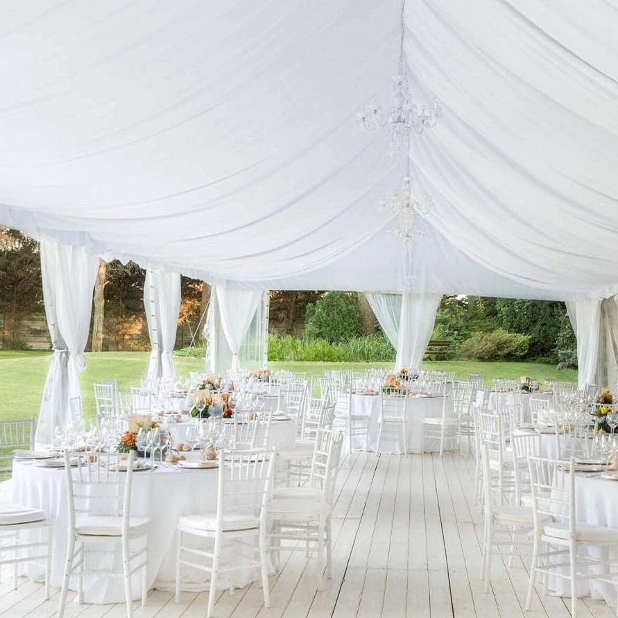 Image of the inside of a luxury white wedding marquee ready for guests