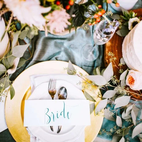 Top-down image of an assortment of table stationery and decorations on a wedding table