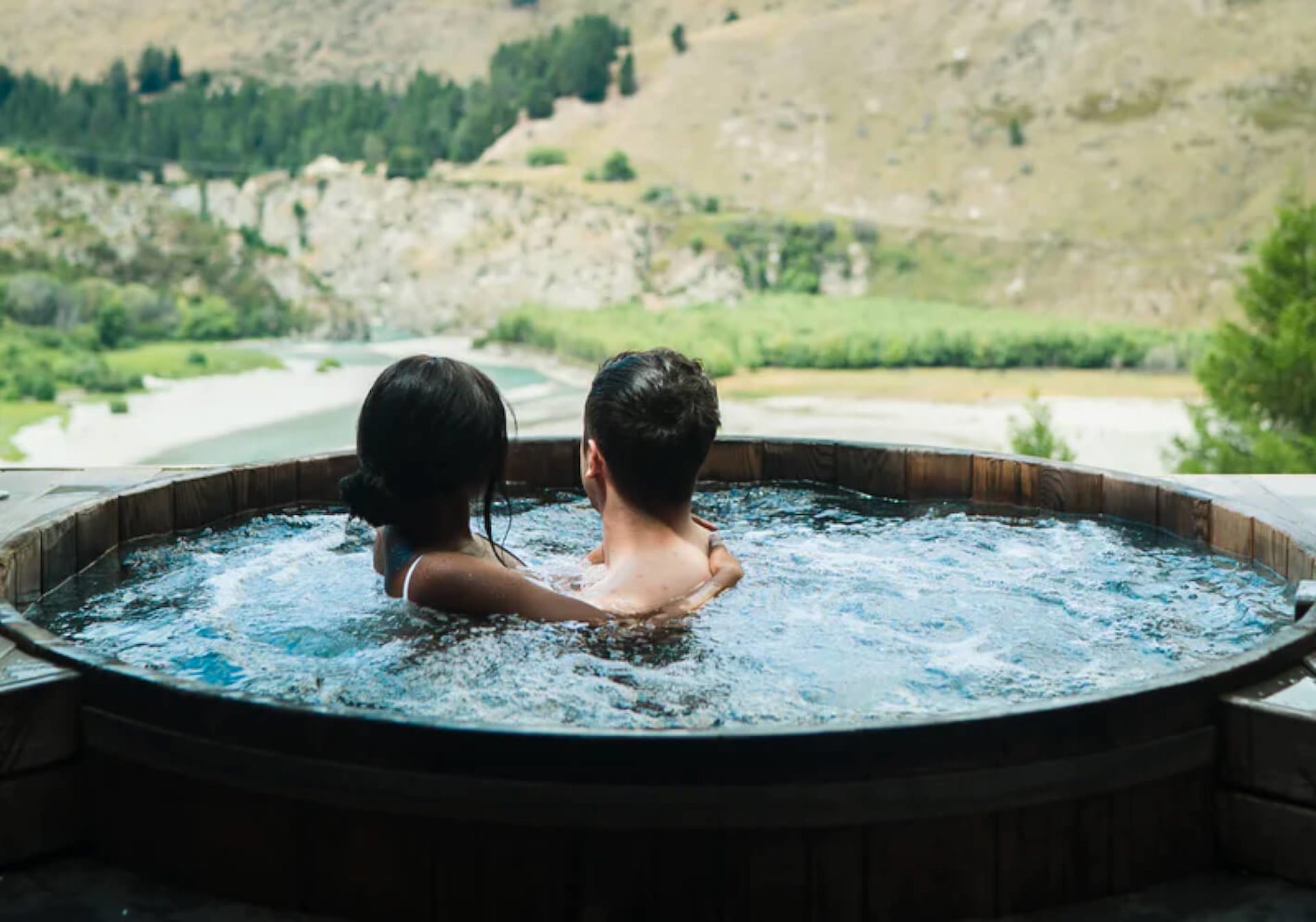 Interracial couple enjoying a luxury hot tub