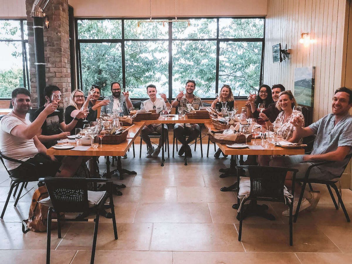 The team enjoying the wine tasting session at Woodchester Vineyard