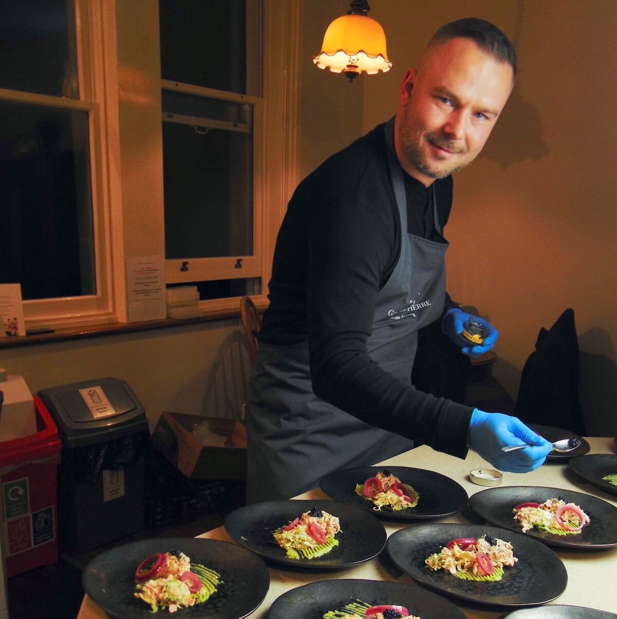 Peter, from Gourmand Pierre, plating the dishes ready for our fine-dining meal