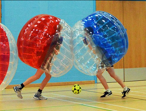 Two bubble football players colliding with each other