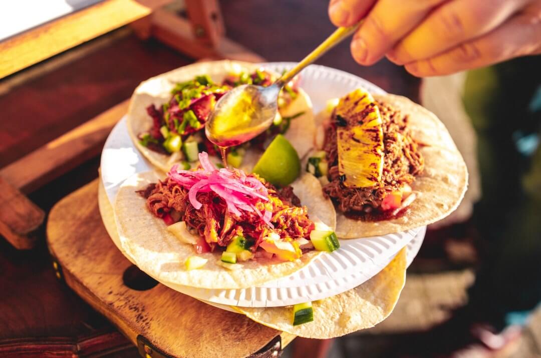 Three colourful and exotic tacos served from Hermanos Tacos