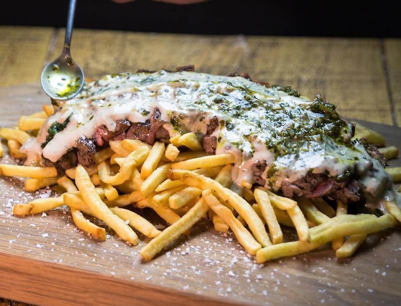 Loaded fries with steak and white sauce from Gourdans Steak Fries