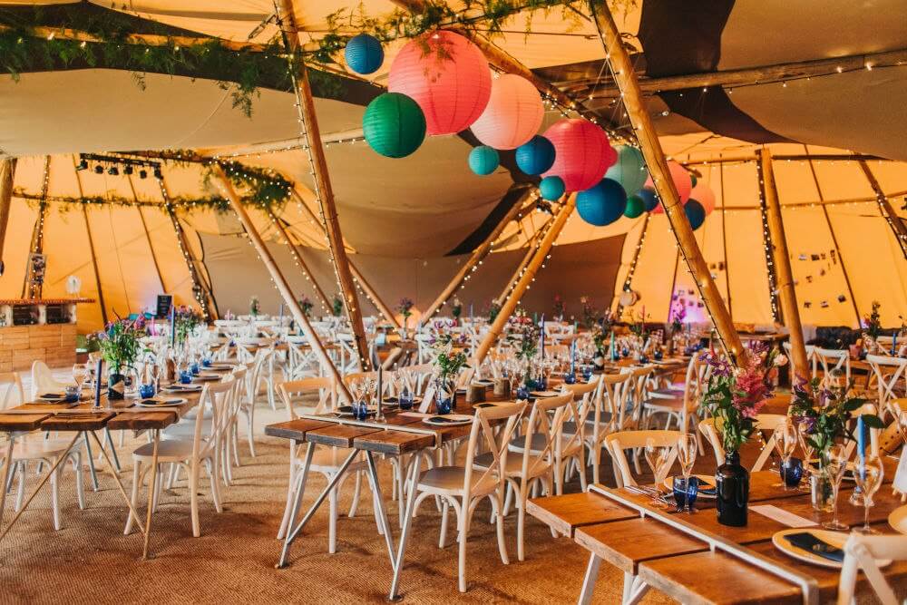 Interior of tipi-style marquee with decorations and tables