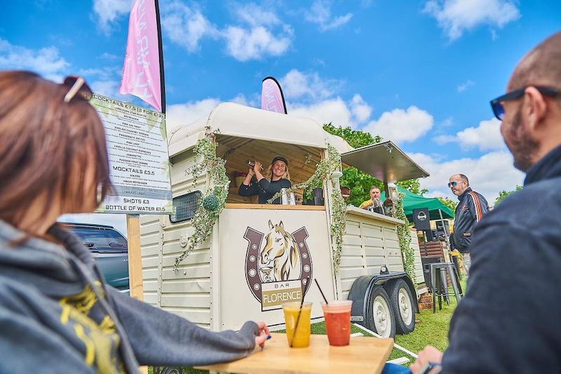 Horsebox bar with bartender shaking cocktail at event