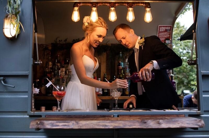 Newly-married couple serving drinks in the Gin Inn bar