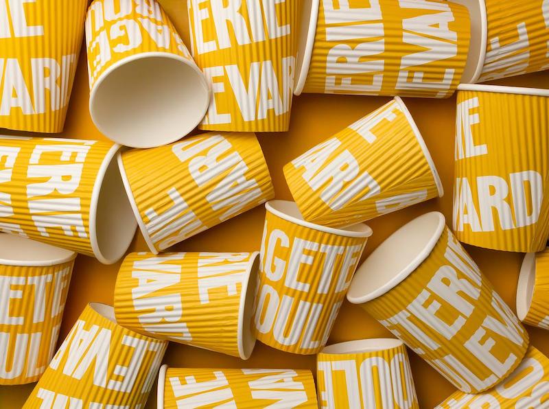 Assortment of yellow recyclable drinks cups for an event