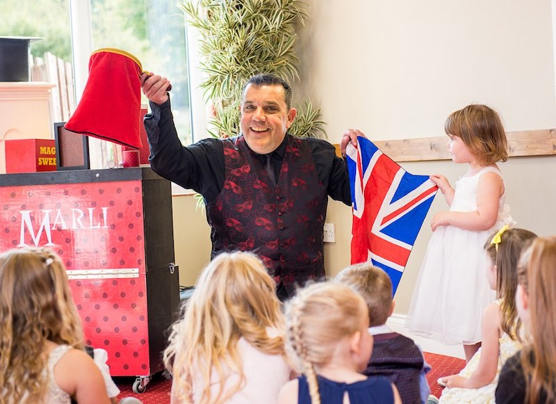 Marc Lemezma performing magic in front of children