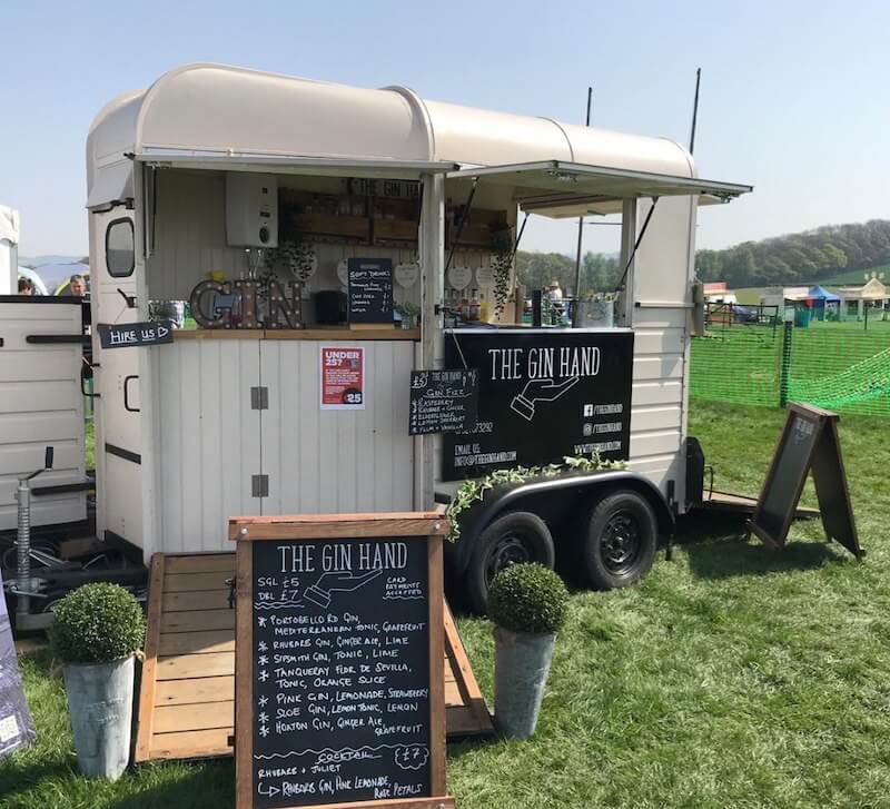 The Gin Hand horsebox mobile bar at a sunny outdoor festival