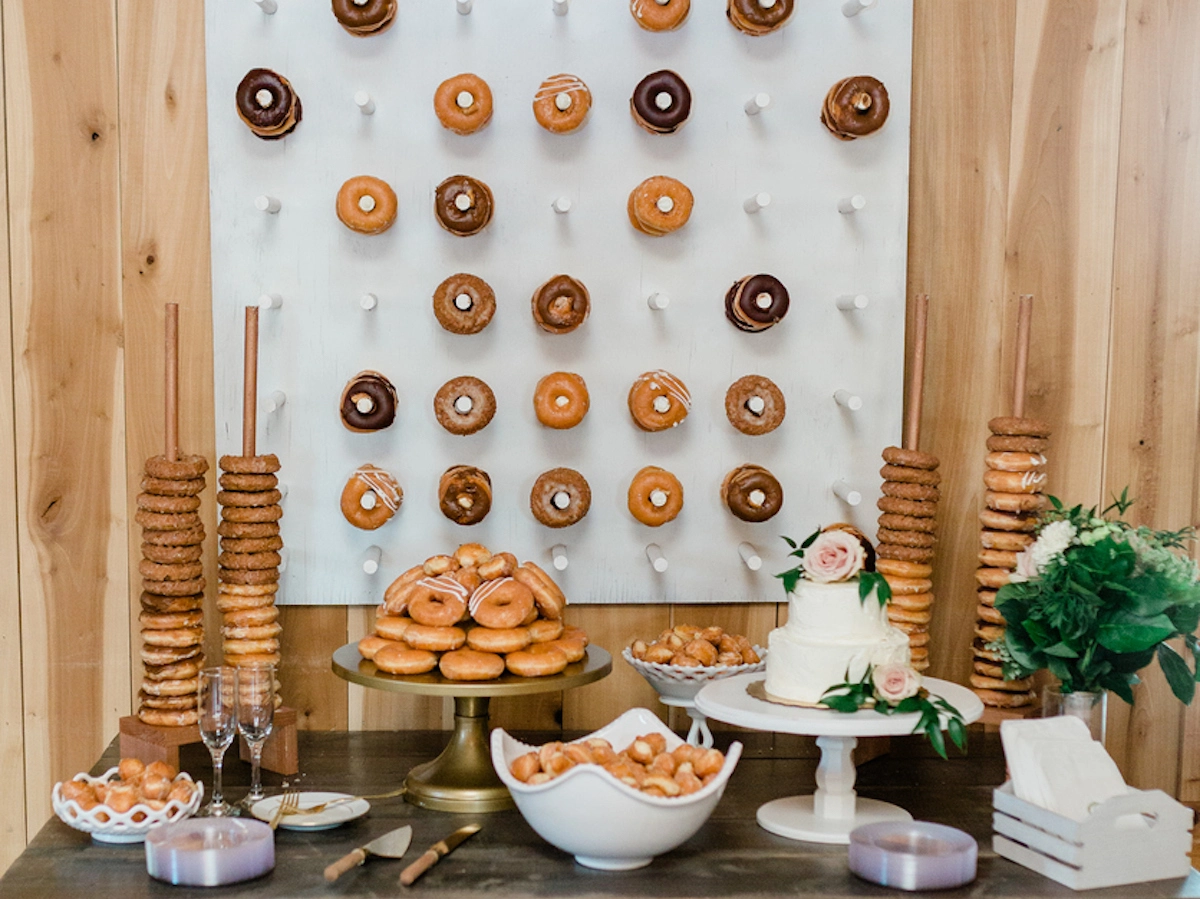 Donut walls, towers and plates set up at a wedding