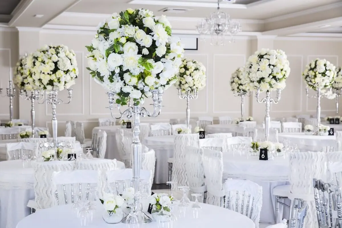 White wedding flower and table arrangement by Boomz Event Services