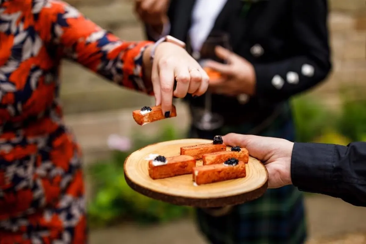 Canapés with caviar served to wedding guests 