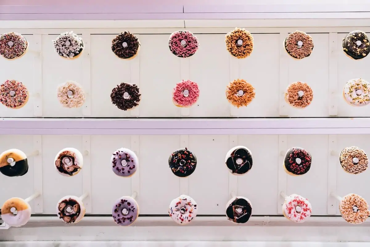 Assortment of donuts hanging on donut wall at a wedding