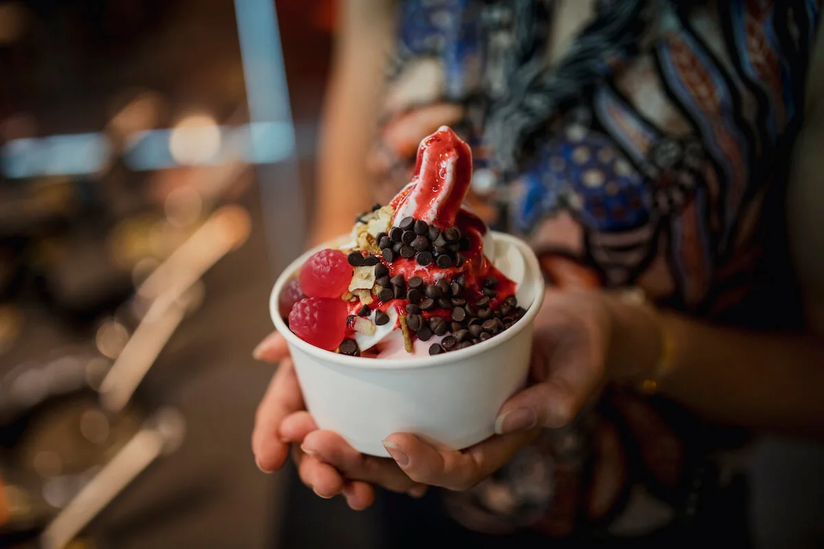 Up close view of frozen yoghurt with an variety of toppings