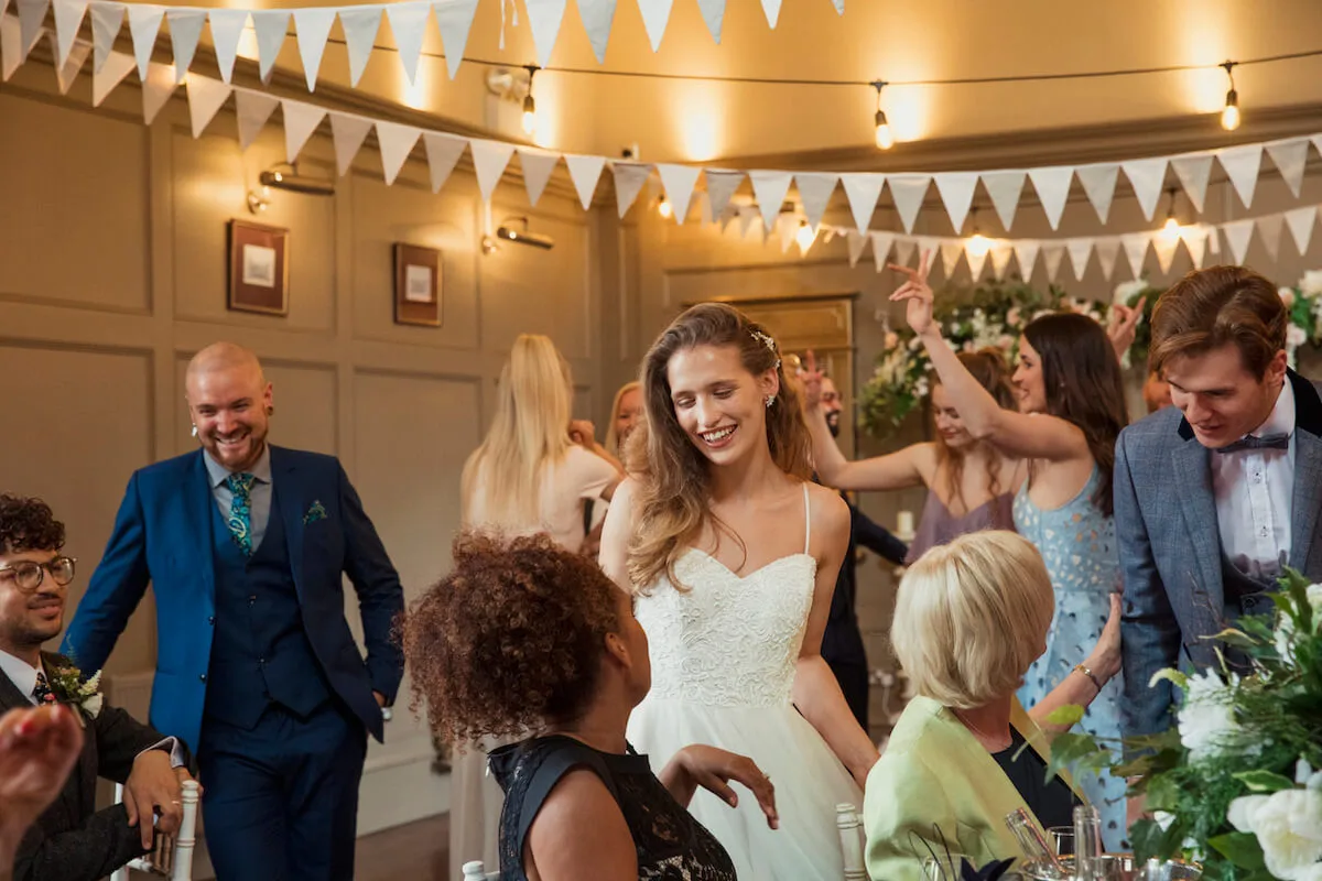 Bride making the rounds at her wedding in a glamorous venue