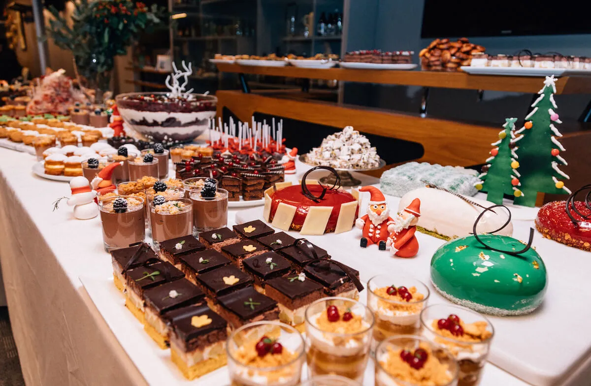 A great selection of festive desserts on a dessert table at an office Christmas party