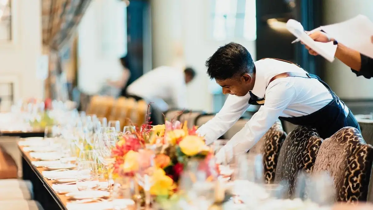 Catering staff preparing table for service