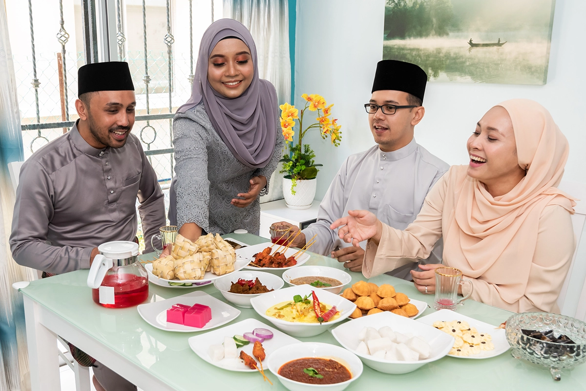A Muslim family enjoying a selection of food for Eid celebrations