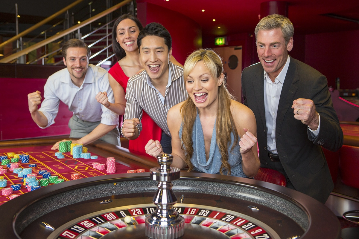 A group of friends enjoying the thrill of the roulette wheel in a casino